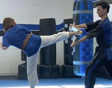 teen breaking board in martial arts school in Orlando
